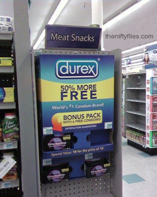 A display of condoms underneath a sign advertising Meat Snacks