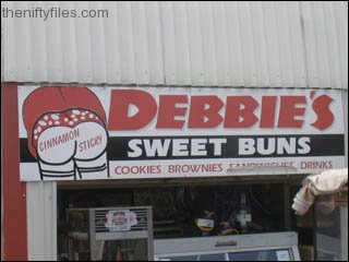 Debbies Cinnamon Sticky Sweet buns - sign appears to show a woman's rear end