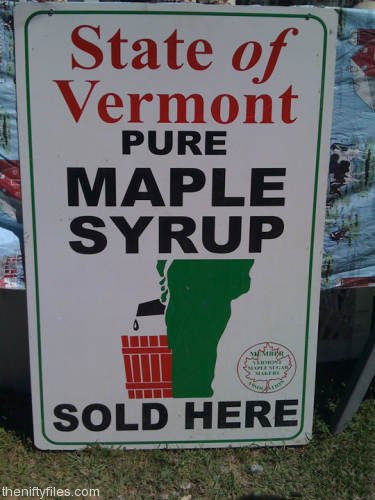 Sign for maple syrup looks like the state of Vermont is dripping into a pail from it's penis